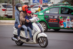 Family riding a scooter